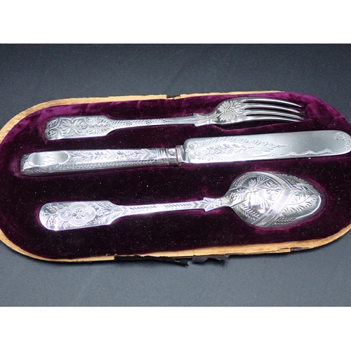 64 - A Victorian silver Christening Knife, Fork and Spoon with bright-cut decoration, London 1886/8, in c... 