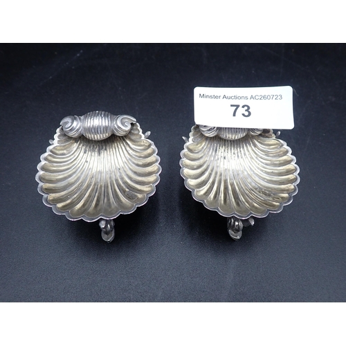 73 - A pair of Victorian silver scallop Salts on dolphin supports, London 1875