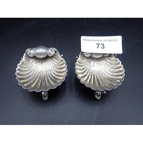 73 - A pair of Victorian silver scallop Salts on dolphin supports, London 1875