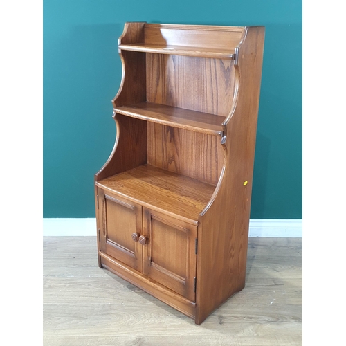 8 - An elm Ercol Waterfall Bookcase with open shelves, above pair of panelled doors, 3ft 7