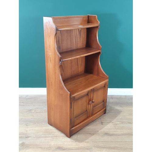 8 - An elm Ercol Waterfall Bookcase with open shelves, above pair of panelled doors, 3ft 7