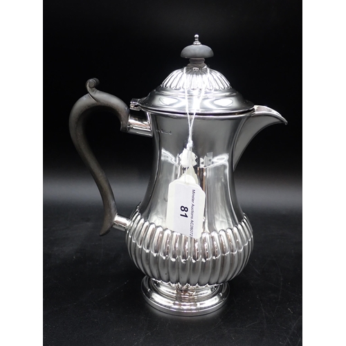 81 - An Edward VII silver Hot Water Jug of semi-fluted baluster form having ebonised scroll handle, Birmi... 