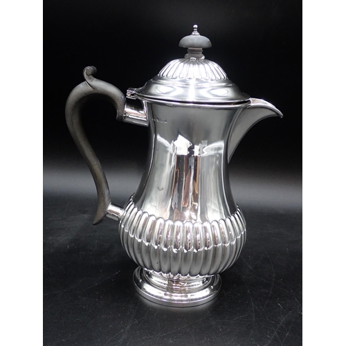 81 - An Edward VII silver Hot Water Jug of semi-fluted baluster form having ebonised scroll handle, Birmi... 