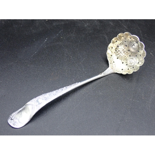 84 - A George III silver Sifting Spoon with fruit embossed bowl, trellis pattern stem with vacant cartouc... 