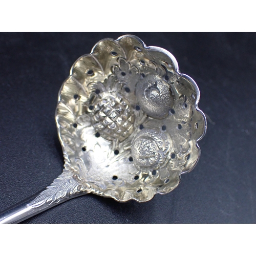 84 - A George III silver Sifting Spoon with fruit embossed bowl, trellis pattern stem with vacant cartouc... 