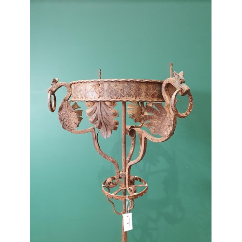 9 - An Arts & Crafts style wrought iron Standing Lamp with Dragon and leafage designs on twisted support... 