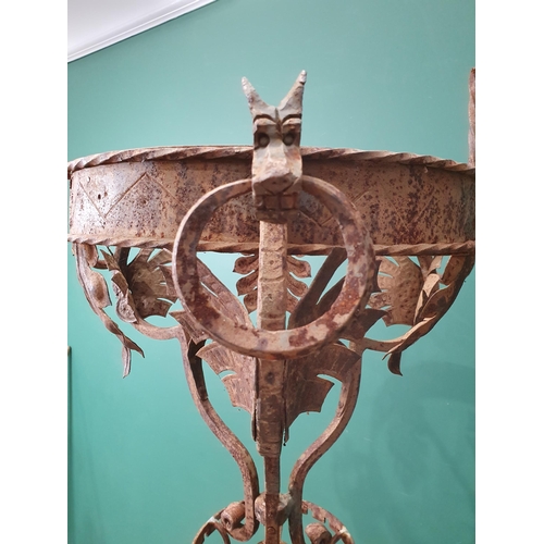 9 - An Arts & Crafts style wrought iron Standing Lamp with Dragon and leafage designs on twisted support... 