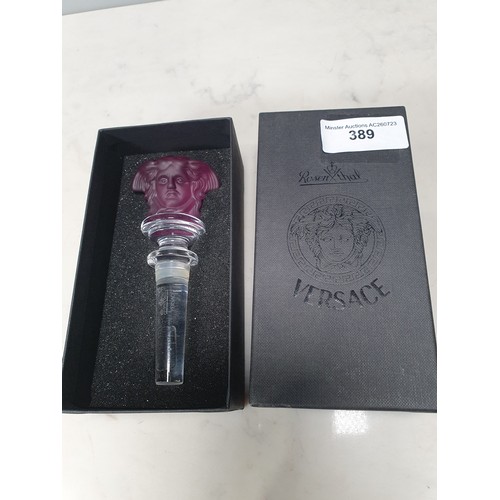 389 - A Versace amethyst Bottle Stopper in the form of a mask, 5 1/4in boxed