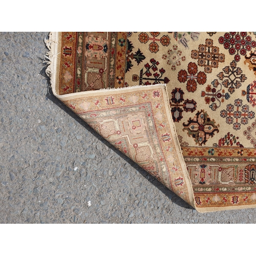 209A - A Persian Carpet on ivory ground with palmettes 7ft 9in x 5ft 5in