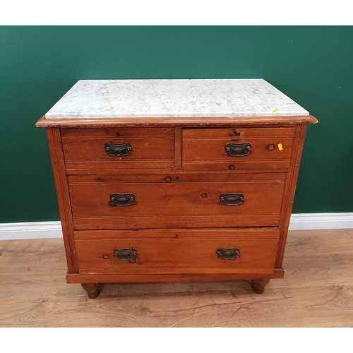 10 - A stained pine Chest of two short, two long Drawers with marble top, raised on turned bun feet A/F, ... 