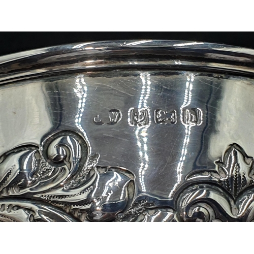 103 - An Edward Vll silver Bowl with floral and scroll embossing, vacant cartouches