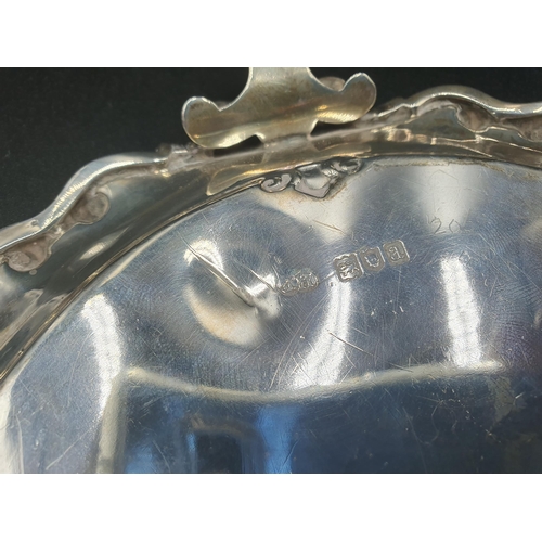 110 - A Victorian silver shaped circular Waiter with floral scroll engraving on three shaped feet, London ... 