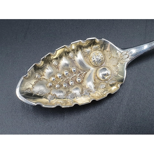 134 - A George III silver Fruit Spoon with gilt berry embossed bowl, floral engraved stem with vacant cart... 