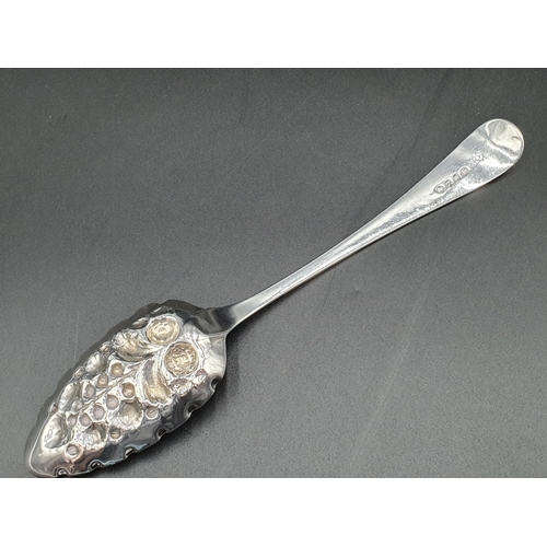 134 - A George III silver Fruit Spoon with gilt berry embossed bowl, floral engraved stem with vacant cart... 