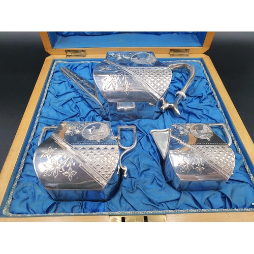 137 - A Victoria white metal three piece Aesthetic movement Tea Set, in original fitted wooden case, with ... 