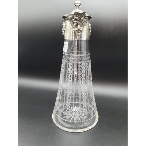 141 - A plated mounted Claret jug with harebell friezes, mask spout and knop finial