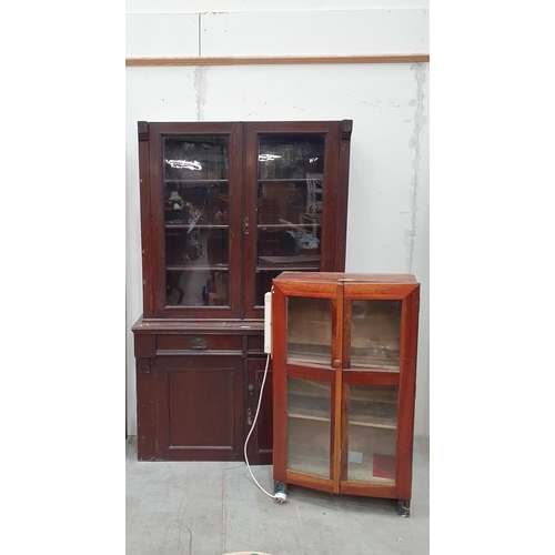 16 - A stained wood glazed topped Bookcase, the pair of glazed doors, above to fitted drawers and pair of... 