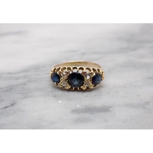 160 - A Sapphire and Diamond Ring pavé-set three graduated round sapphires with eight-cut diamonds and one... 