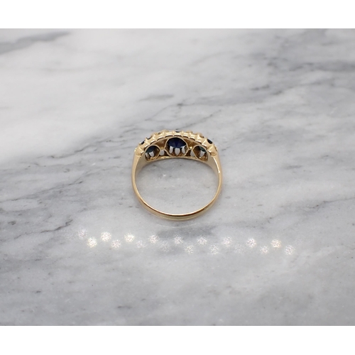 160 - A Sapphire and Diamond Ring pavé-set three graduated round sapphires with eight-cut diamonds and one... 