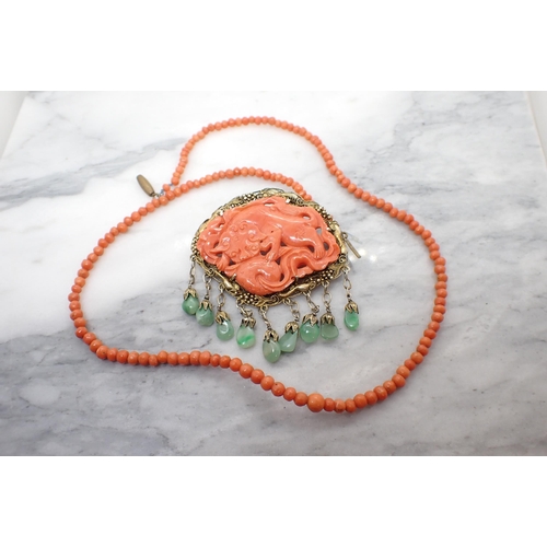 170 - A Coral bead Necklace and a Coral Brooch with carved dragon in gilt metal frame suspending polished ... 