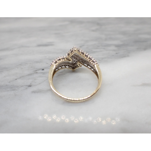 189 - A contemporary Diamond Crossover Ring peg-set numerous baguette and brilliant-cut stones in 9ct gold... 