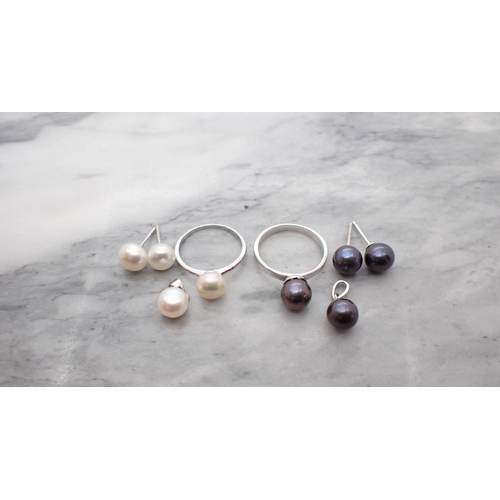 205 - A small Cultured Pearl Pendant with Ring and Earrings en suite in silver and a similar Set with blue... 