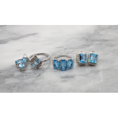 206 - Two Dress Rings stamped 925 set blue topaz together with a pair of Earrings and a Pendant