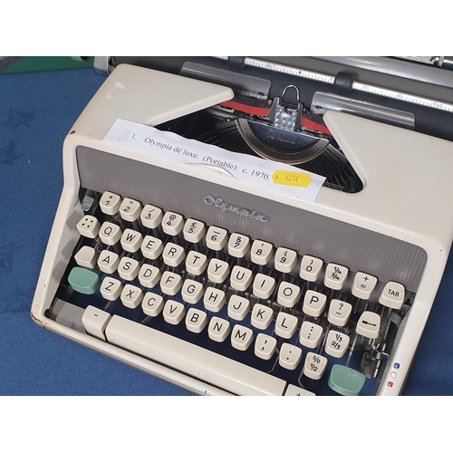 21 - An Olympia de luxe portable Typewriter, an Adler Gabriele 25 Typewriter and a Olympia Monica electri... 