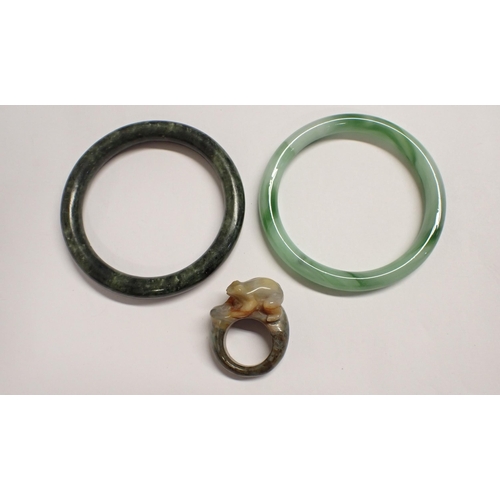 210 - A modern jade Bangle, another Bangle and a jade Frog Ring