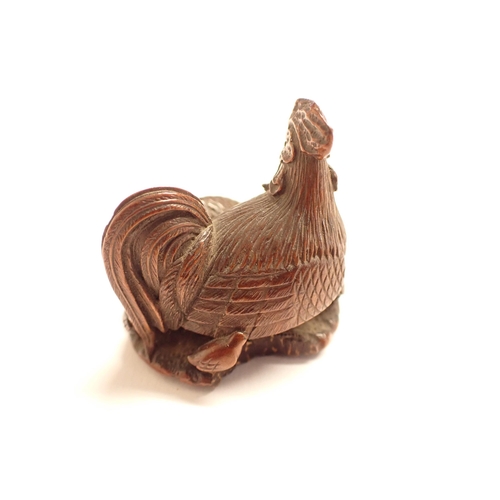 218 - A treen Netsuke formed as a cockerel and his family