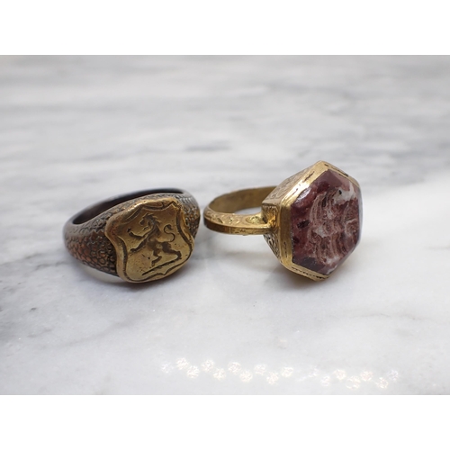 235 - Two seal Rings in yellow metal, one set hardstone