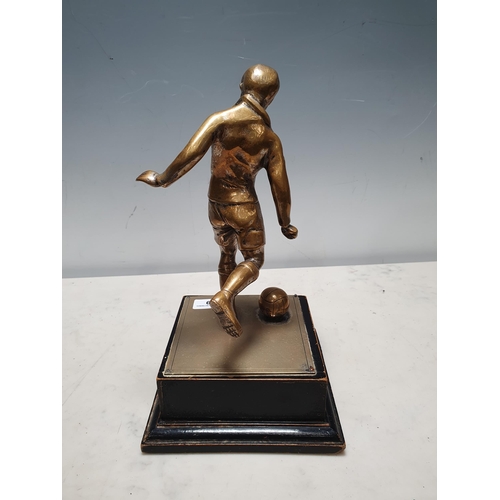 249 - A brass Figure of a footballer and an ebonised wooden plinth, 11in H