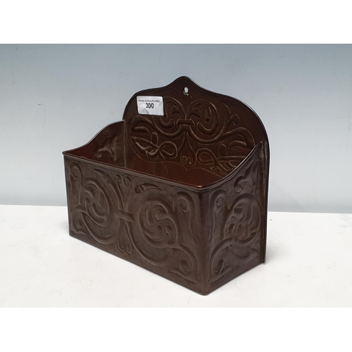 300 - A copper arts and crafts wall mounted open Candle Box, with a typical stylized hammered decoration