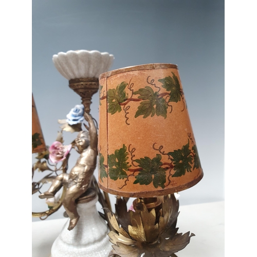 316 - A pair of three branch Table Lamps with trailing rose design and cherub figural support 13in W x 12i... 