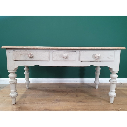 33 - An antique pine scrub top Farmhouse Table with white painted base fitted three frieze drawers on tur... 