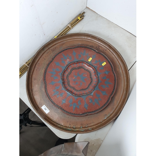 354 - A large circular brass Tray with central scrolled and leafage designs on three bun feet, a continent... 