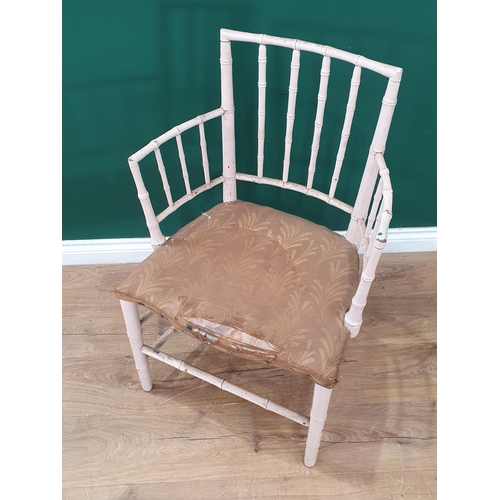 39 - A 19th Century white painted bamboo effect open Elbow Chair