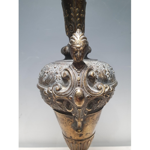 4 - A brass Vase/Urn with pair of figure heads with scrolled designs on circular pedestal base, A/F, 15