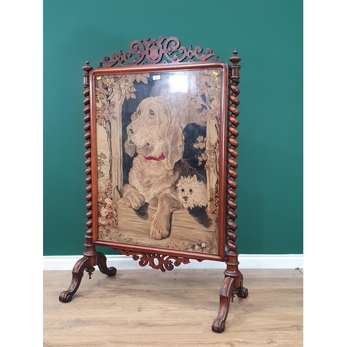 40 - A Victorian walnut framed Firescreen with needlework of a hound beneath fretwork frieze and flanked ... 