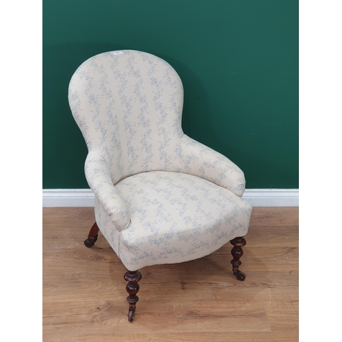 476 - A 19th Century Armchair with white and blue floral upholstery mounted on turned front supports 2ft 1... 