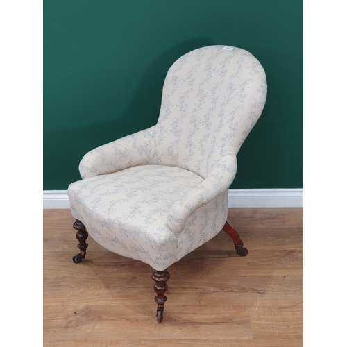 476 - A 19th Century Armchair with white and blue floral upholstery mounted on turned front supports 2ft 1... 