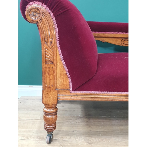 487 - An Edwardian oak framed Chaise Lounge with claret upholstery 5ft 10in L x 2ft 8in H