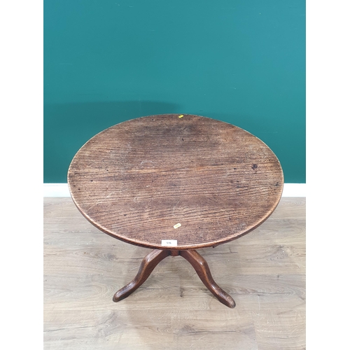 516 - An oak circular top Tripod Table on turned column, 2ft 4