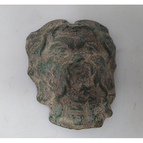 52 - A small Roman type Bronze Mask of a bearded man, along with a lead Figure in the style of a standing... 