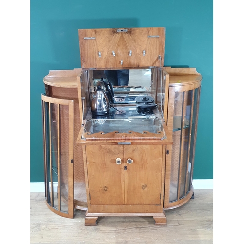 524 - A walnut veneered bow front Drinks Cabinet, with fall front compartment above pair of cupboard doors... 