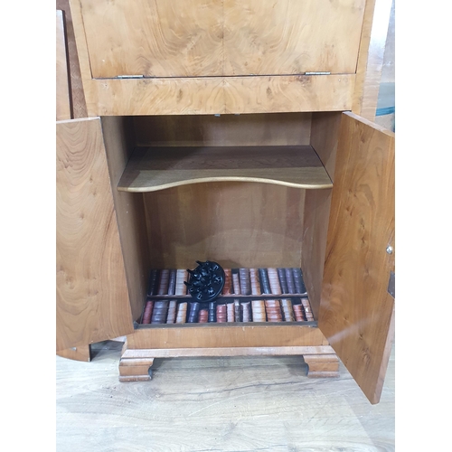 524 - A walnut veneered bow front Drinks Cabinet, with fall front compartment above pair of cupboard doors... 