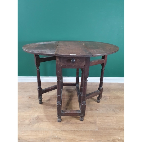 538 - An antique oak Gateleg Table with single fitted drawer, on turned supports united by square stretche... 