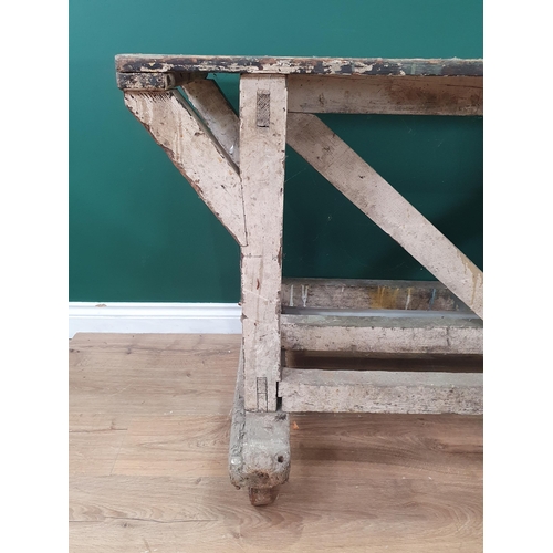 581 - A painted industrial Artists Table/Bench on square supports and stretchers and large metal castors, ... 