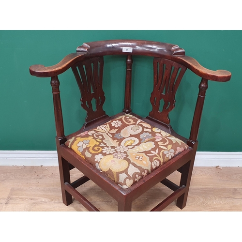 67 - A Georgian mahogany Corner Chair with shaped arms, turned supports, upholstered drop in seat, replac... 