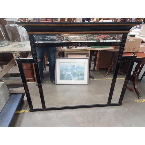 808 - An ebonised Over mantle Mirror with gilt carved floral decorations, 3ft 7